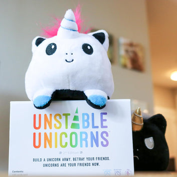 Kids Mandi Unstable Unicorns card game with magical creatures concept